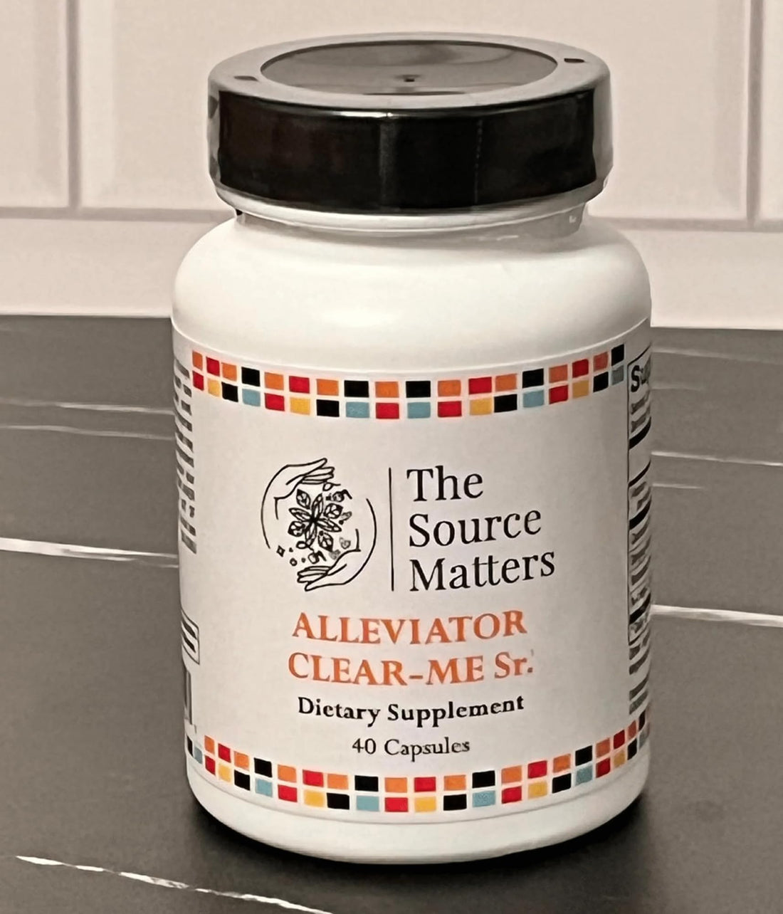 Supplement bottle labeled 'The Source Matters' on a white background