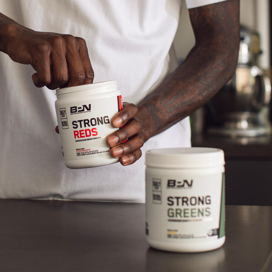 Three supplement containers from Bare Performance Nutrition on a white background